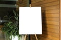 A blank white canvas sits on an artist\'s easel in a studio. The canvas is pristine and Royalty Free Stock Photo