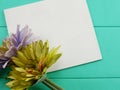 Blank white card and artificial gerbera flower valentines day on green background