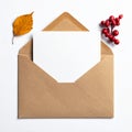 Blank White Card in Brown Envelope with Autumn Foliage on White Background Royalty Free Stock Photo