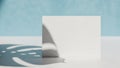 Blank white card casting shadow of monstera leaf on textured surface with blue background Royalty Free Stock Photo