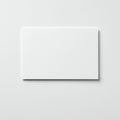 A blank, white card on a light grey, textured surface. The card has a smooth texture, Royalty Free Stock Photo