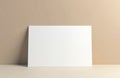 Blank white card mockup on beige background for design message. Clean paper invitation, greeting template. Simple minimalistic