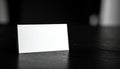 Blank white card on a dark textured surface in black and white paper empty Royalty Free Stock Photo