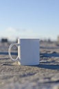 Blank white coffee mug on a salty ground