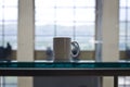 A blank white coffee mug on the study glass table Royalty Free Stock Photo