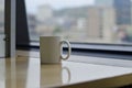 A blank white coffee mug on the table edge Royalty Free Stock Photo