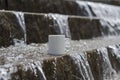 A blank white coffee mug on the water steps Royalty Free Stock Photo
