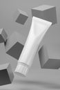 Blank white cosmetic tube on gray background Royalty Free Stock Photo