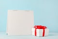 Blank white desk calendar and Christmas gift box with red ribbon bow Royalty Free Stock Photo