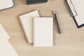 Blank white diaries cover with pen on light wooden table. Mockup Royalty Free Stock Photo