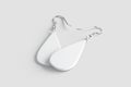 Blank white drop earring pair mockup lying, grey background Royalty Free Stock Photo