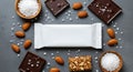 Blank white energy bar surrounded by almonds and dark chocolate squares mockup Royalty Free Stock Photo