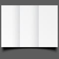 Blank white folding paper flyer at Gray background. Royalty Free Stock Photo