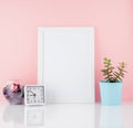Blank white frame and plant cactus, on a white table against the pink wall with copy space. Mockup with copy space. Royalty Free Stock Photo