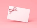 Blank white gift card or gift voucher with pink rope ribbon bow on pink pastel color background minimal concept Royalty Free Stock Photo