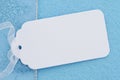 Blank white gift tag on blue felt Royalty Free Stock Photo