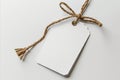 Blank white gift tag with rope on a white background Royalty Free Stock Photo