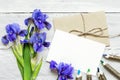 Blank white greeting card with blue iris flowers bouquet and envelope Royalty Free Stock Photo