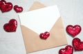 Blank white greeting card with brown envelop and hearts on marble table. Mockup valentines day concept. Royalty Free Stock Photo