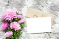 Blank white greeting card with pink aster flowers bouquet and envelope Royalty Free Stock Photo