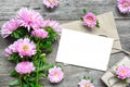 Blank white greeting card with pink aster flowers bouquet and envelope with flower buds and gift box Royalty Free Stock Photo