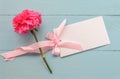 Blank white greeting card with pink Carnation flower