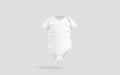 Blank white half sleeve baby bodysuit mockup, gray background Royalty Free Stock Photo