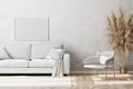 Blank white horizontal frame mock up in Light coloured minimalistic living room interior with white and gold sofa and armchair Royalty Free Stock Photo
