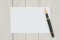 Blank white index card with a pen on weathered wood Royalty Free Stock Photo