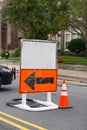 Blank white information road sign on top of an orange detour sign with a black arrow Royalty Free Stock Photo