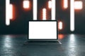 Blank white laptop display on dark concrete surface with abstract blurry nights lights background. Mockup Royalty Free Stock Photo