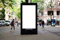 blank white lightbox ad panel along sidewalk. bus shelter advertising. blurred urban background Royalty Free Stock Photo