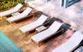 Blank white loungers mock up near swimming pool Royalty Free Stock Photo