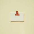 Blank white memo paper with coral clip on yellow desk background. top view, copy space Royalty Free Stock Photo