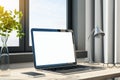 Blank white mock up laptop screen on table with notepad and lamp