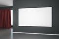 Blank white mock up poster on black wall in modern empty room with concrete floor and red curtain Royalty Free Stock Photo