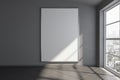 Blank white mock up poster on grey wall in empty room with big window and ceramic floor Royalty Free Stock Photo