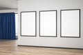 Blank white mock up posters on white wall in modern empty room with wooden floor and blue curtain Royalty Free Stock Photo
