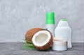 Blank white mockup jar and dispenser bottles of cosmetic products with fresh coconut and green palm leaves Royalty Free Stock Photo