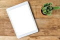 Blank modern digital tablet on a wooden desk Royalty Free Stock Photo