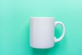 Blank White Mug Mockup on Light Turquoise Background. Template Space for Creative Artwork Lettering Royalty Free Stock Photo