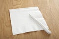 Blank White Napkin or Serviette and Pen on Wooden Surface Royalty Free Stock Photo