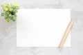 Blank white note paper and pencils on white marble background, f Royalty Free Stock Photo