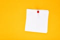 Blank white note paper pinned with a push pin on a yellow board Royalty Free Stock Photo