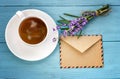 blank white notebook,envelope, bunch of lavender and cup of coffee on the desk Royalty Free Stock Photo