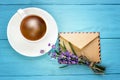 blank white notebook,envelope, bunch of lavender and cup of coffee on the desk Royalty Free Stock Photo