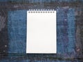 Blank white notebook on indigo blue background