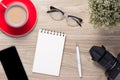 Blank white notebook open, eyeglass, pen and cup of coffee on the desk Royalty Free Stock Photo