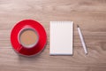 Blank white notebook open, eyeglass, pen and cup of coffee on the desk Royalty Free Stock Photo