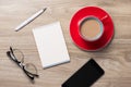 Blank white notebook open, eyeglass, pen and cup of coffee on the desk Royalty Free Stock Photo